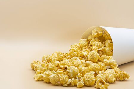 paper bucket of popcorn on color backgroundの写真素材