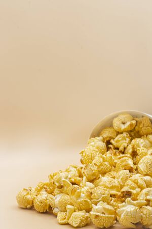 paper bucket of popcorn on color backgroundの写真素材