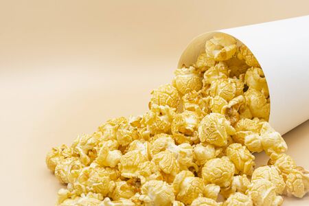 paper bucket of popcorn on color backgroundの写真素材