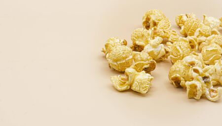 Delicious popcorn with caramel on color backgroundの写真素材