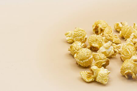 Delicious popcorn with caramel on color backgroundの写真素材