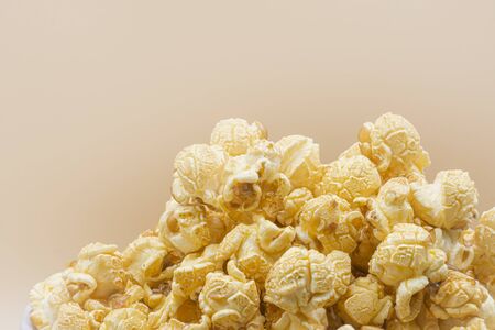 Delicious popcorn with caramel on color backgroundの写真素材