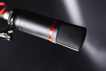 Sound studio. Microphone with cable isolated on black backgroundの写真素材