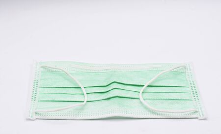 Anti-virus and dust mask that has been used on a white background.の写真素材