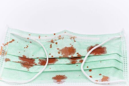 Dirty mask already using Used and dirty blood mask on a white background.