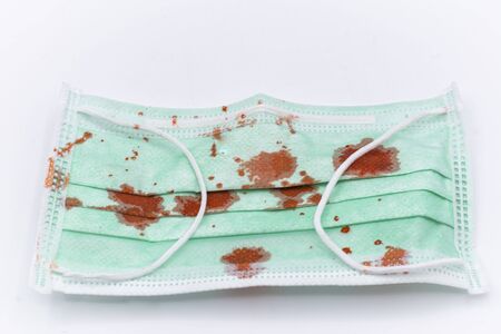 Dirty mask already using Used and dirty blood mask on a white background.の写真素材