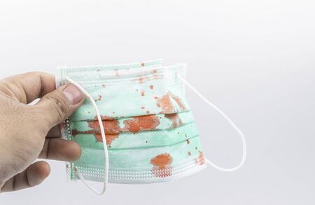 Dirty mask already using Used and dirty blood mask on a white background.の写真素材