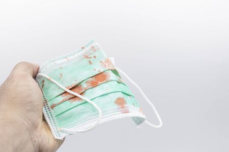 Dirty mask already using Used and dirty blood mask on a white background.の写真素材