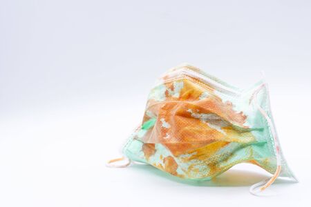 Dirty mask already using Used and dirty blood mask on a white background.の写真素材