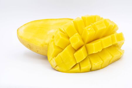 Yellow  mango slice with cubes isolated white backgroundの写真素材