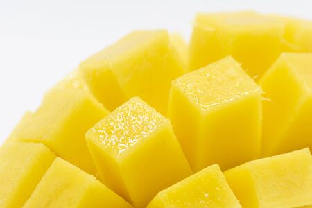 Yellow  mango slice with cubes isolated white backgroundの写真素材