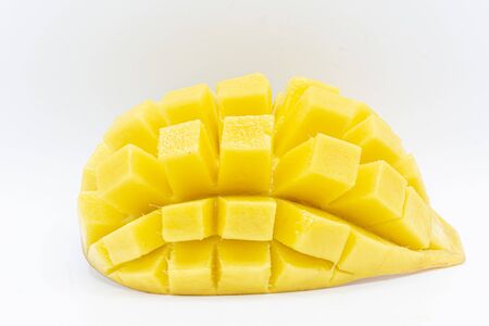 Yellow  mango slice with cubes isolated white backgroundの写真素材