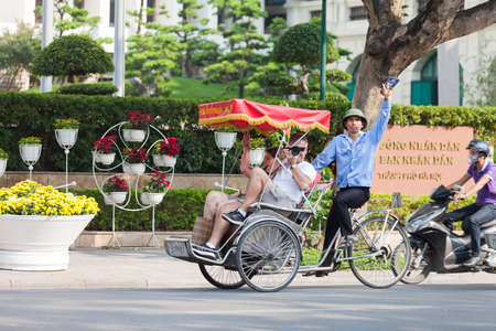 Hanoi, Vietnam - Feb 27, 2020: Hanoi old quarter main square, rickshaw drivers carrying tourists around town.のeditorial素材