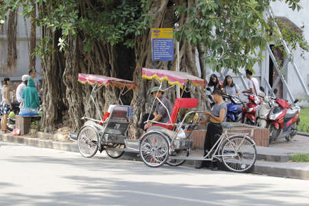 Hanoi, Vietnam - October 27, 2019: Hanoi old quarter main square, rickshaw drivers carrying tourists...