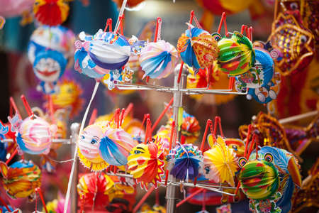 Traditional market sells colorful lanterns with different shapes, lion heads, drums... for the mid-autumn festival. The market is organized at Old Quarter, Hanoi.の写真素材