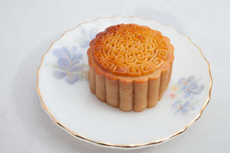 Vietnamese mid autumn festival cake. Mooncakes are traditional pastries eaten during the Mid-Autumn Festival. The festival involves family getting together to share mooncakes while watching the moonの写真素材