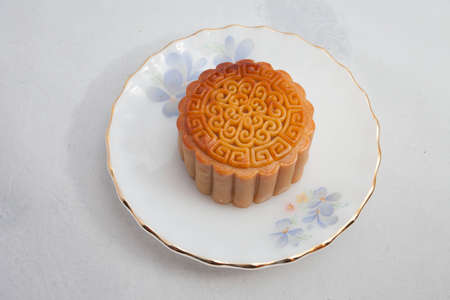 Vietnamese mid autumn festival cake. Mooncakes are traditional pastries eaten during the Mid-Autumn Festival. The festival involves family getting together to share mooncakes while watching the moonの写真素材