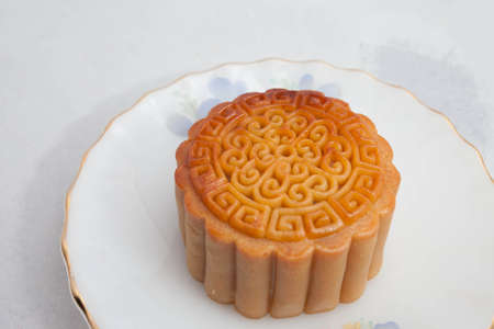 Vietnamese mid autumn festival cake. Mooncakes are traditional pastries eaten during the Mid-Autumn Festival. The festival involves family getting together to share mooncakes while watching the moonの写真素材
