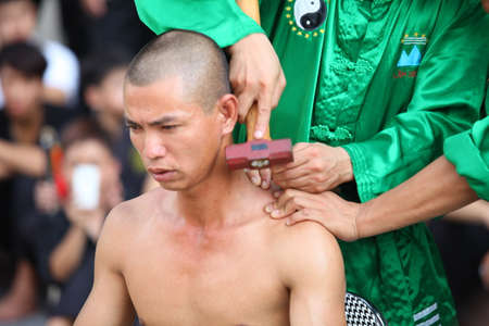 Hanoi, Vietnam - Aug 9, 2015: Vietnamese pugilists in traditional costume doing a performance of martial arts on a public and free entrance event in Hanoi capital.のeditorial素材