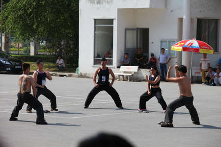 Hanoi, Vietnam - Aug 9, 2015: Vietnamese pugilists in traditional costume doing a performance of martial arts on a public and free entrance event in Hanoi capital.のeditorial素材