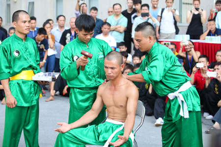 Hanoi, Vietnam - Aug 9, 2015: Vietnamese pugilists in traditional costume doing a performance of martial arts on a public and free entrance event in Hanoi capital.のeditorial素材