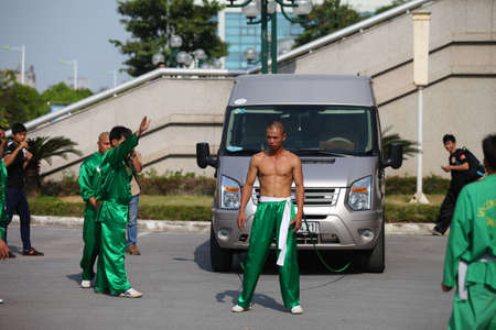 Hanoi, Vietnam - Aug 9, 2015: Vietnamese pugilists in traditional costume doing a performance of martial arts on a public and free entrance event in Hanoi capital.のeditorial素材