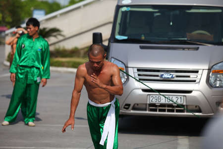 Hanoi, Vietnam - Aug 9, 2015: Vietnamese pugilists in traditional costume doing a performance of martial arts on a public and free entrance event in Hanoi capital.のeditorial素材