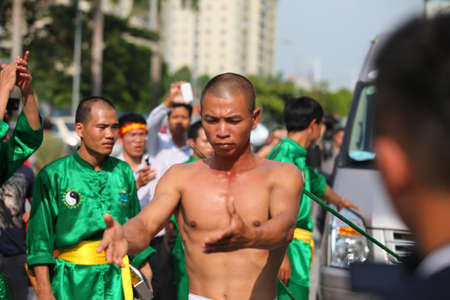 Hanoi, Vietnam - Aug 9, 2015: Vietnamese pugilists in traditional costume doing a performance of martial arts on a public and free entrance event in Hanoi capital.のeditorial素材