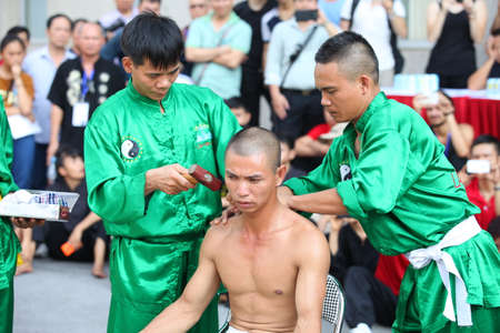 Hanoi, Vietnam - Aug 9, 2015: Vietnamese pugilists in traditional costume doing a performance of martial arts on a public and free entrance event in Hanoi capital.のeditorial素材