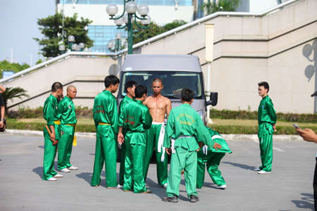 Hanoi, Vietnam - Aug 9, 2015: Vietnamese pugilists in traditional costume doing a performance of martial arts on a public and free entrance event in Hanoi capital.のeditorial素材