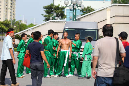 Hanoi, Vietnam - Aug 9, 2015: Vietnamese pugilists in traditional costume doing a performance of martial arts on a public and free entrance event in Hanoi capital.のeditorial素材