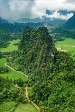 Lush and green mountain view of Vang Vieng, Laos, during the rainy season.の写真素材