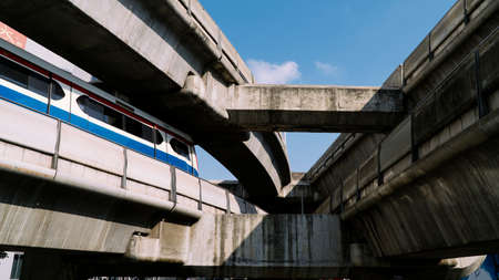 BTS train car runs on large cement track system above city in Bangkok, Thailand.の写真素材