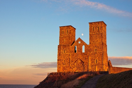 Remains of Reculver church towers bathed in late afternoon sun in winterの写真素材