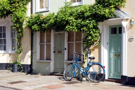 A blue bicycle leaning against a house in Sandwich Kentの写真素材