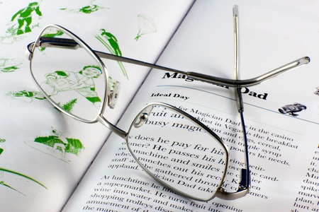 Close-up of a pair of spectacles resting on a book