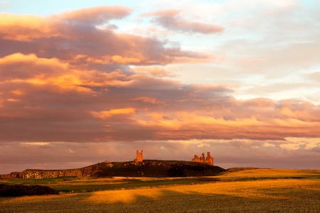 Sunset at Dunstanburgh Castleの写真素材