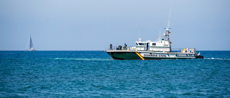 Guardia Civil boat using nets to try and recover somethingのeditorial素材