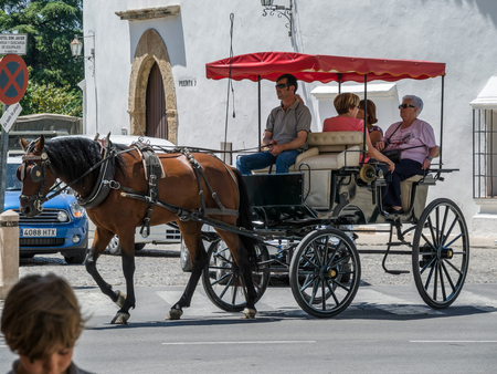 Tourists enjoying a ride in a hosre drawn carriage in Ronda