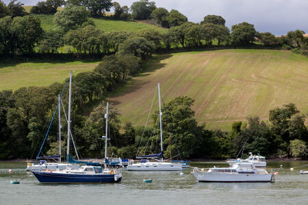 Boats moored on the River Dartの写真素材