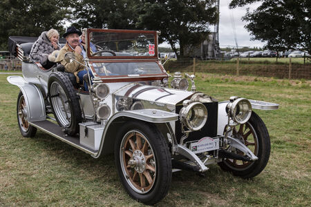 Three people sitting in a vintage silver Rolls Royceのeditorial素材