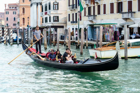 Gondolier ferrying people in Veniceのeditorial素材