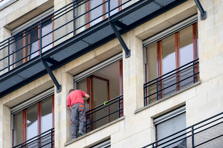 Man carrying out repairs to a balcony in Berlinの写真素材