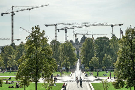 Multitude of cranes towering over the gardens of the cathedral in Berlinのeditorial素材