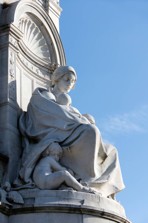 Statue of a Woman with Children at the Victoria Memorial outside Buckingham Palace in Londonのeditorial素材