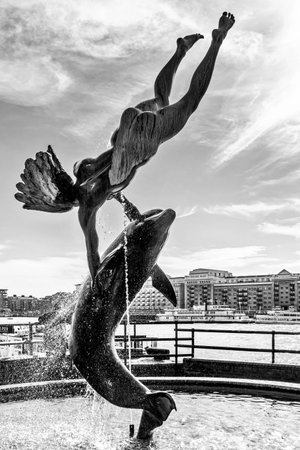 David Wayne sculpture "Girl with the dolphin" next to Tower Bridge in Londonのeditorial素材