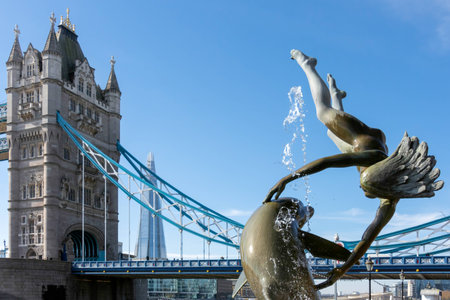 David Wayne sculpture "Girl with the dolphin" next to Tower Bridge in Londonのeditorial素材