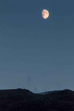 Moon rising over the Cairngorm mountainsの写真素材
