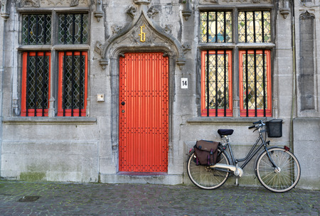Bicycle outside a property in Market Square Bruges West Flanders Belgiumのeditorial素材