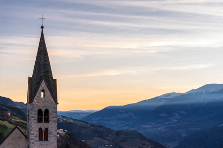 Belfry of the Parish Church in Villanders at Sunriseの写真素材